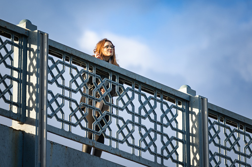 Beautiful young tourist woman portrait on Galata bridge.