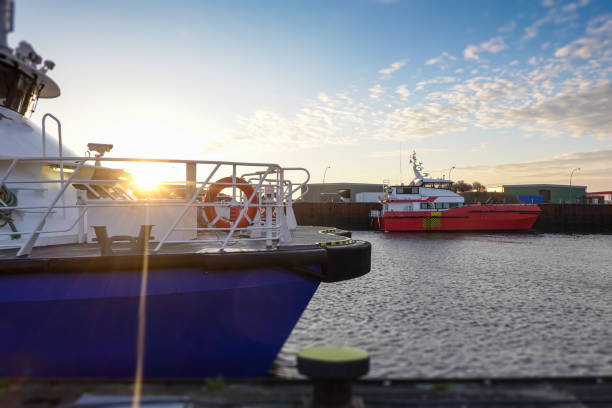 passenger transporting ships in morning light prepared for transporting people to Borkum offshore find farms. Ship, boat, vessel, recscue boat
