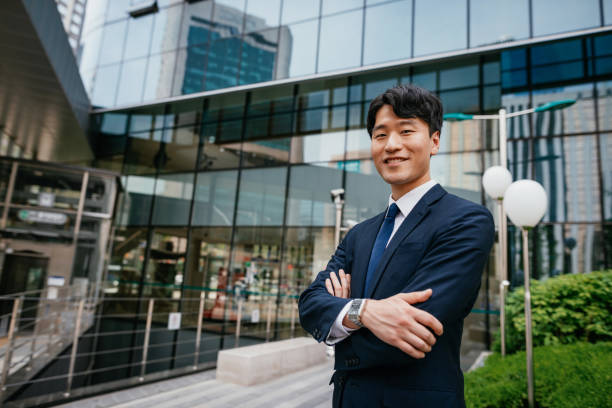 istock Korean businessman in full suit looking at camera 1985173575