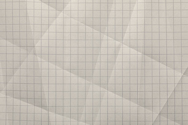Close-up of graph ruled composition or exercise book paper with rough texture.