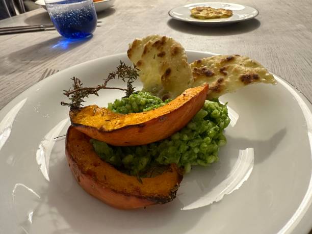 istock Fried pumpkin, parsley risotto and hemp bread 1985207310