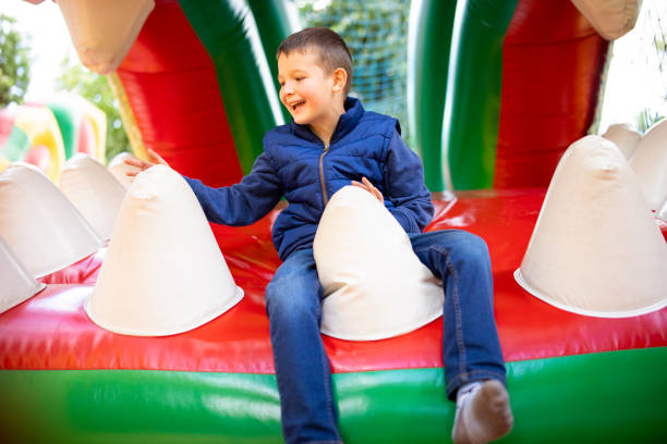 istock Boy Laughing on Bouncy Castle 1985210412