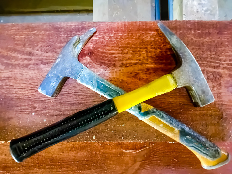 two hammers with an abstract background, as a tool for hammering nails and others. High quality photo