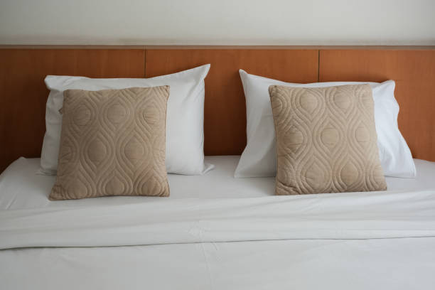 istock Pillows on bedsheets in bedroom hotel. 1985249775