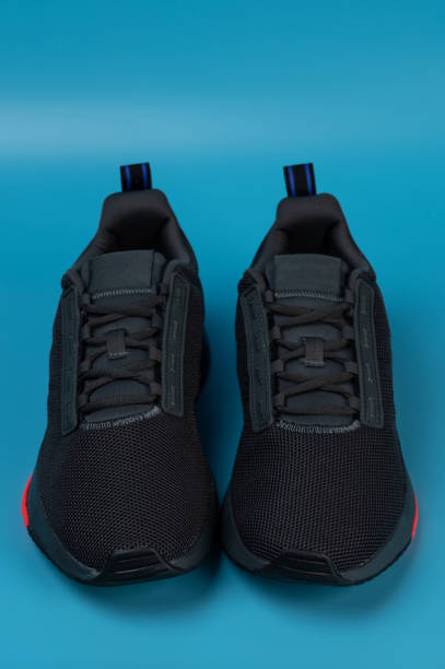 Sneaker sport running shoes front view isolated on blue  studio background