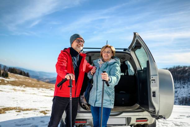 istock Couple on hiking taking backpacks from the car trunk 1985309401