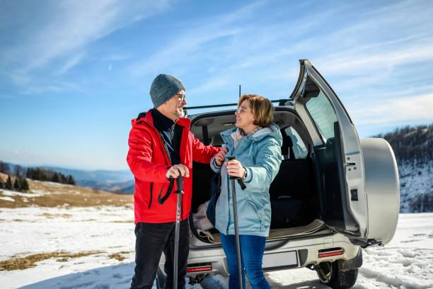 istock Couple on hiking taking backpacks from the car trunk 1985321424