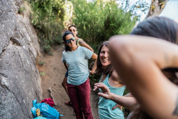 istock Friends talking and taking a break during hike outdoors 1985371489