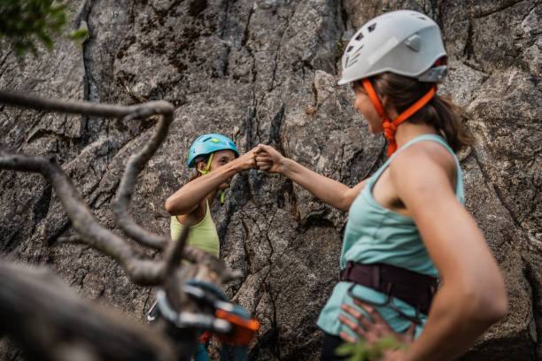 Climber friends  touch fists during a climbing
