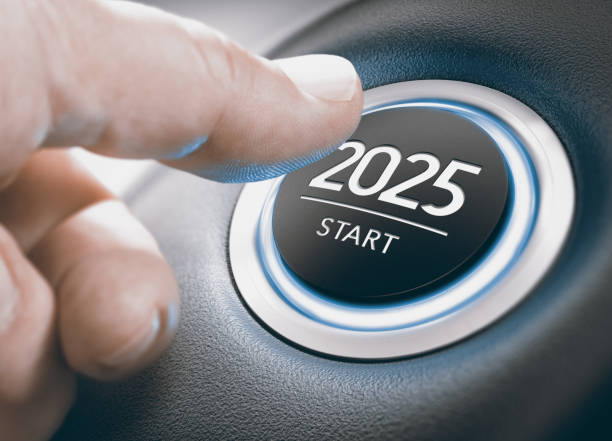 Year 2025 Start, Two Thousand and Twenty Five Concept. Finger pressing a car ignition button with the text 2025 start. Year two thousand and twenty five concept. Composite image between a hand photography and a 3D background. start button stock pictures, royalty-free photos & images