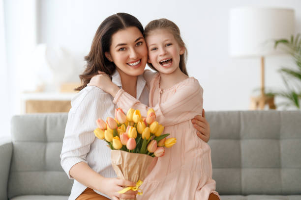 istock daughter and mom with flowers 1985436854