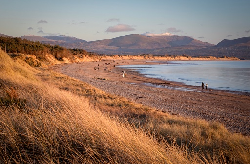 Sand dunes and Snowdonia backdrop from Llanddwyn beach, Anglesey, Wales