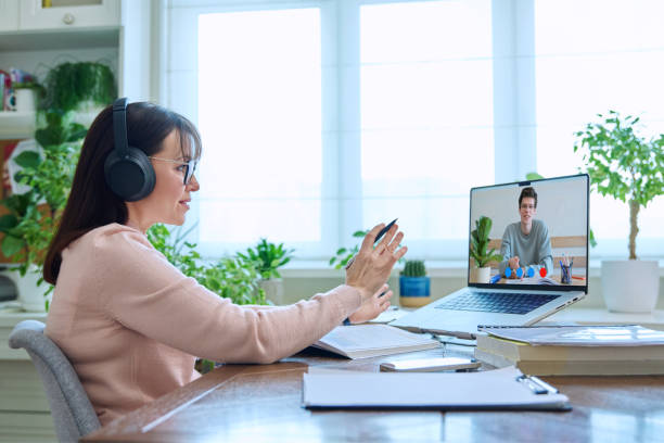 istock Female teacher having video conference, online test lesson with college student guy 1985479040