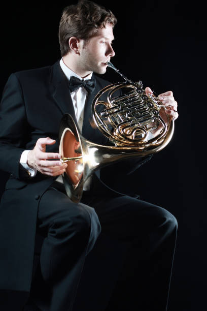 istock French horn player. Classical musician playing horn 1985482151