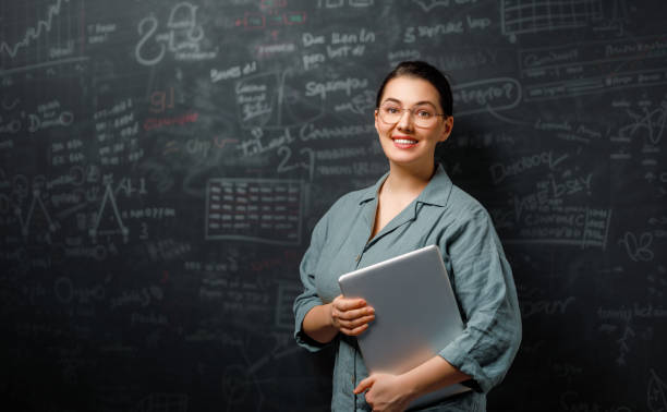 istock teacher on background of blackboard 1985483714