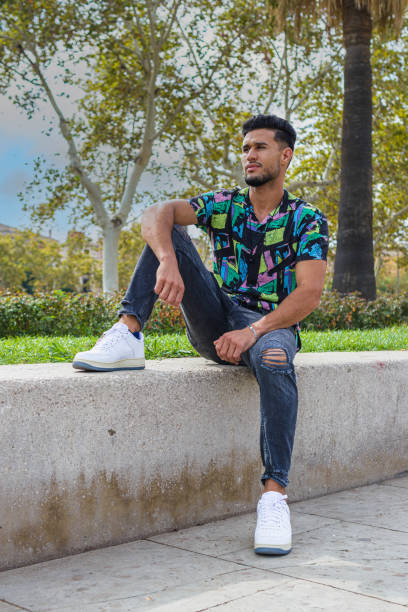istock a nice style moroccan man sitting on a concrete bench o the street 1985496418