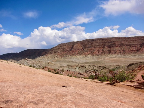 This short, flat trail (100 yards / 91 m) just off to the right,  is the easiest way to see Delicate Arch. The spectacular freestanding natural arch, formed in Entrada Sandstone, is 52 ft. tall (16 m) and can be seen from one mile away. The lovely range of colours of the Navajo Sandstone landscape (red, brown, pink, salmon, gold, and white) results from varying amounts and forms of iron oxide within the rock, and in the case of the white the overall lack of iron. May 9, 2011.