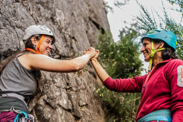 istock Climber friends  doing a high fives during a climbing 1985498666