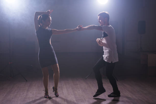 istock Young couple dancing latin dance Bachata, merengue, salsa. Two elegance pose in dance class 1985525283