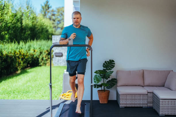 istock Man running on a treadmill at the yard 1985545631