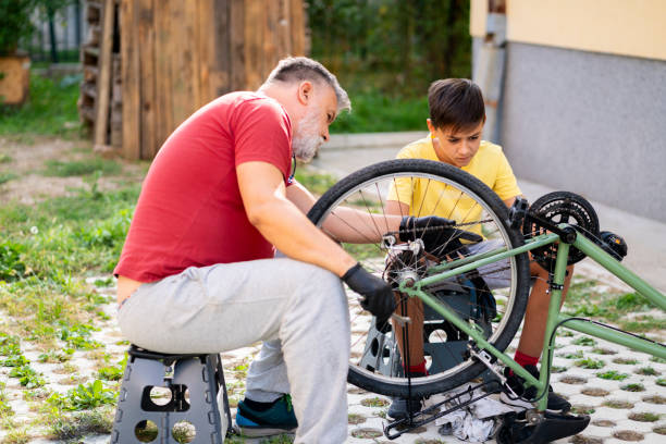istock Father and son repairing a bicycle in backyard 1985548336