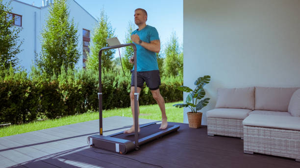 istock Man running on a treadmill at the yard 1985548345