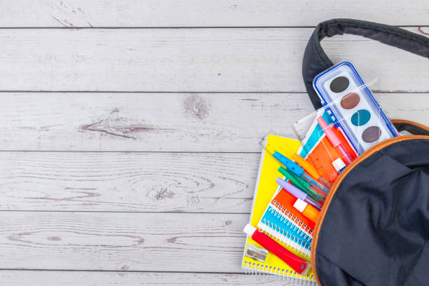 istock OPEN SCHOOL BACKPACK, WITH NOTEBOOKS, PENCILS, TEMPERAS AND WATERCOLORS. BACK TO SCHOOL. 1985570596