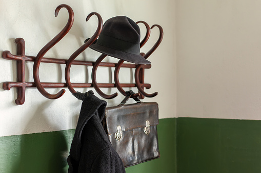 Clothes hanger. Old wooden clothes hanger. Return home from the street. Classic hanging poll. vintage coat and hat hanger in the old style.