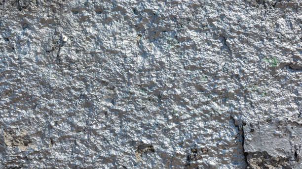 istock The rough concrete wall is painted with silver glitter paint 1985598253