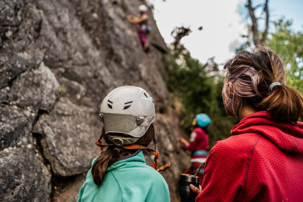 istock Female climbers preparing to climb a mountain 1985599824