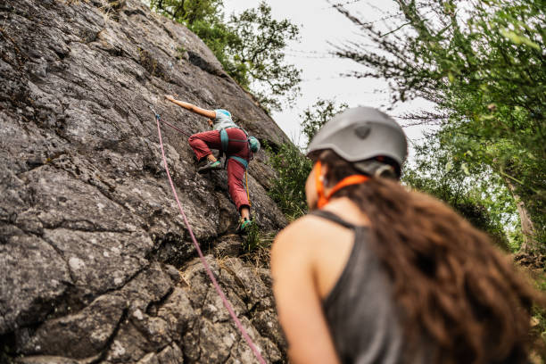 istock Female climber climbing mountain 1985617030
