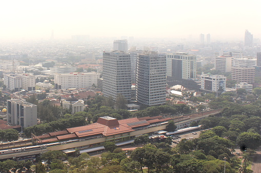 Jakarta, Indonesia - March 7, 2023 - View from a height of the central area of ​​Jakarta City which is shrouded in smog, it is suspected that air pollution is caused by fumes from motor vehicles, industry and others. In several research publications, the city of Jakarta is one of the cities with the highest levels of air pollution in the world.