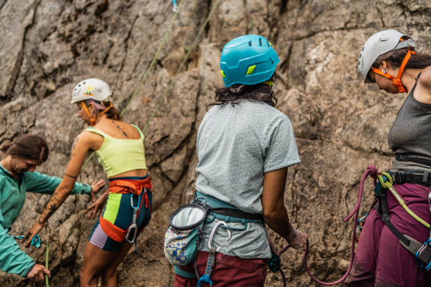 istock Female climbers preparing safety gear for cliff climbing 1985635091