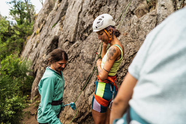 istock Female climbers preparing safety gear for cliff climbing 1985635092