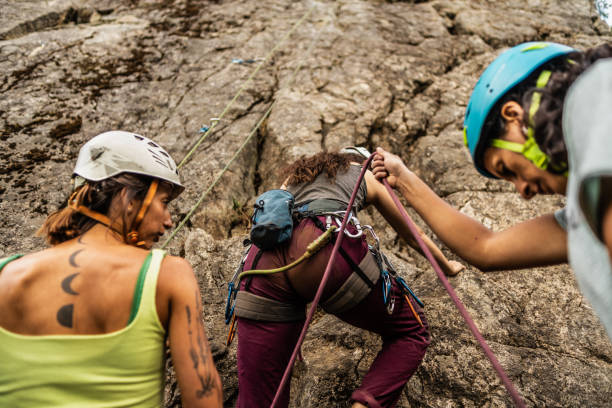 istock Female climbers preparing safety gear for cliff climbing 1985635094