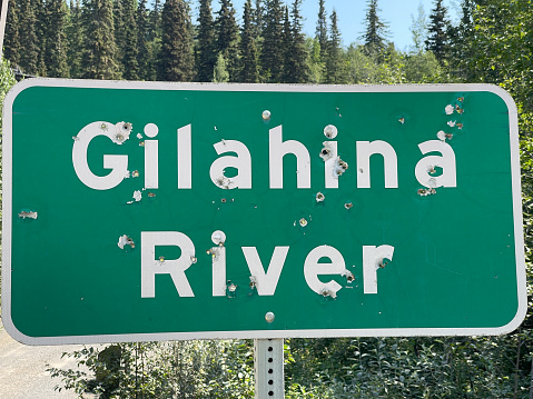 A shot-up sign Gilahina River, The McCarthy Road, Alaska. High quality photo