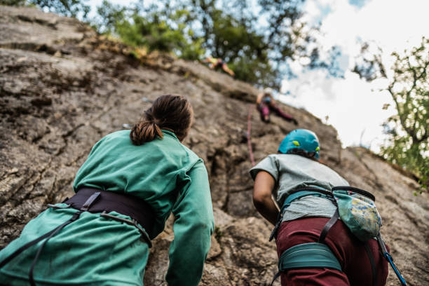 istock Female climbers climbing mountain outdoors 1985639196