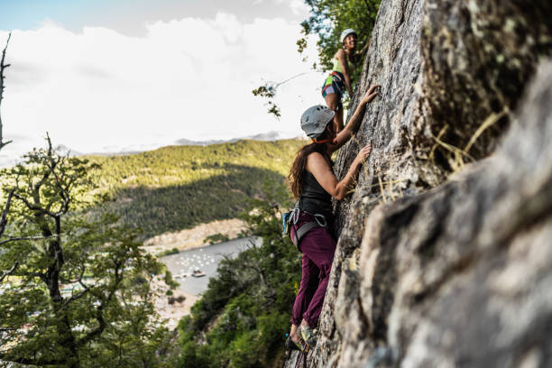 istock Young climbers climbing mountain together 1985639205
