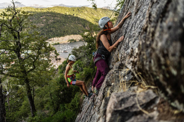 istock Young climbers climbing mountain together 1985639207