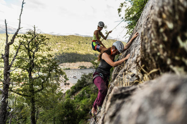 istock Young climbers climbing mountain together 1985639709