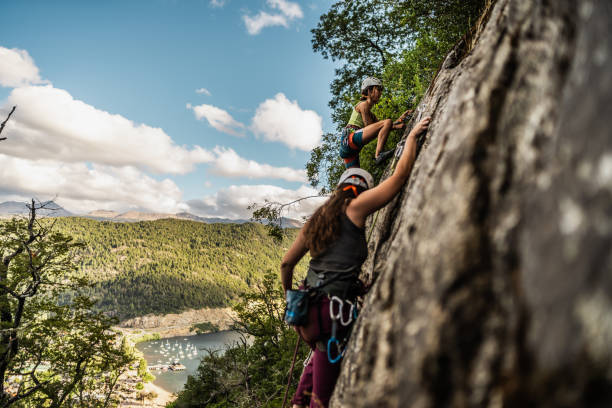 istock Young climbers climbing mountain together 1985639713