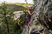 Portrait of young climbers climbing a cliff together