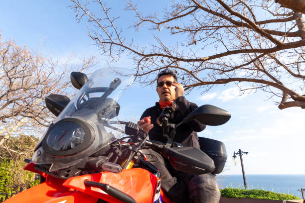 istock Men with a motorbike with apple 1985643832