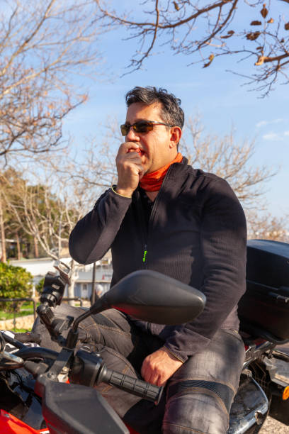 istock Men with a motorbike with apple 1985644850
