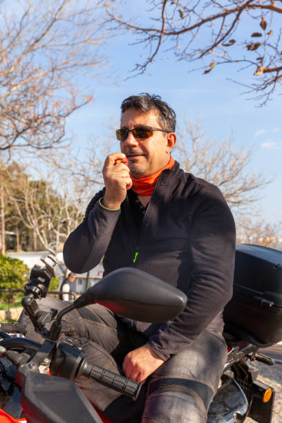 istock Men with a motorbike with apple 1985645373