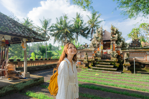 Woman with backpack exploring Balinese temple