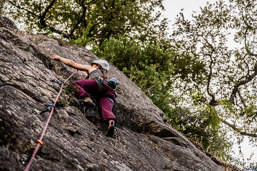 Female climber climbing mountain