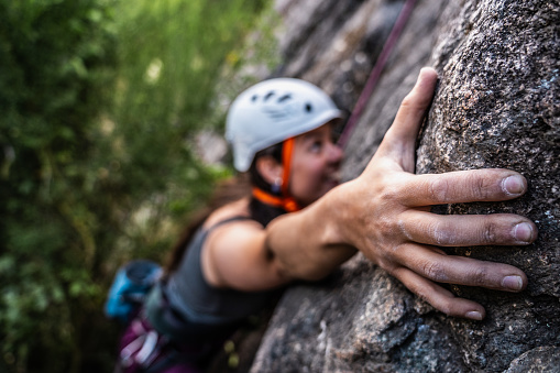 Close-up of a female climber climbing mountain