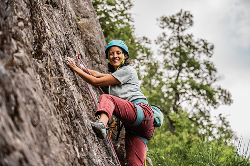 Portrait of a female climber climbing mountain