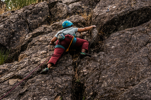 Female climber climbing mountain